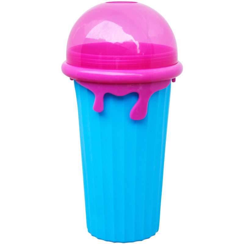 Reusable 500ml slushy maker cup with a blue ribbed freezer cup, pink ice cream-style lid, and matching spoon on a white background. BPA-free DIY smoothie and frozen dessert maker for homemade slushies and milkshakes.