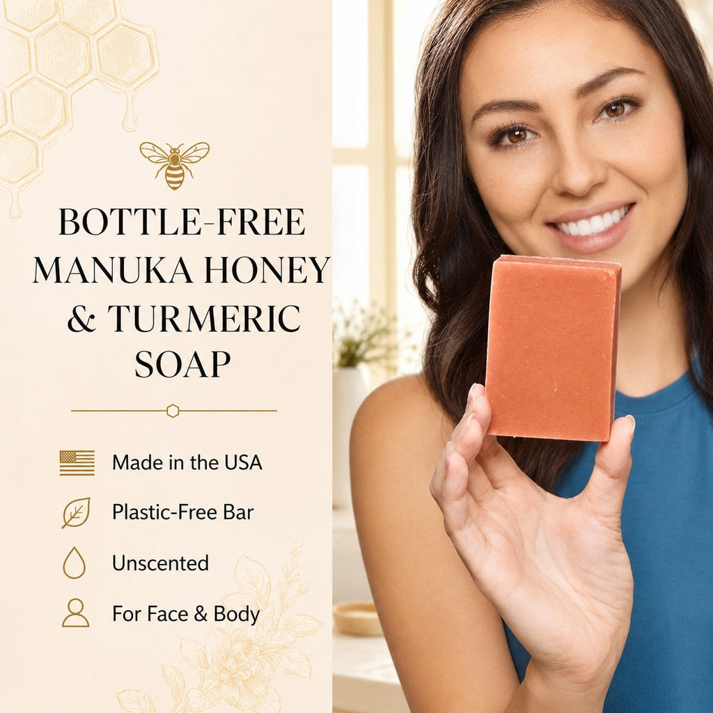 A woman holds up a rectangular bar of manuka honey and turmeric soap in a warm terracotta color. The left side of the image features a beige graphic panel with text reading 'BOTTLE-FREE MANUKA HONEY & TURMERIC SOAP' along with icons indicating it is made in the USA, plastic-free bar, unscented, and suitable for face and body.