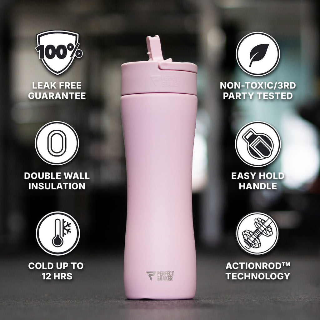 A light pink insulated travel tumbler with a flip-top lid, centered on a dark blurred background with feature callouts around it. The text includes '100% Leak Free Guarantee,' 'Non-Toxic/3rd Party Tested,' 'Double Wall Insulation,' 'Easy Hold Handle,' 'Cold Up to 12 Hours,' and 'ActionRod Technology.