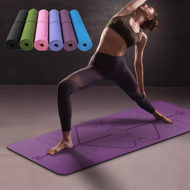 Woman practicing yoga on a purple mat with additional mats in the background.