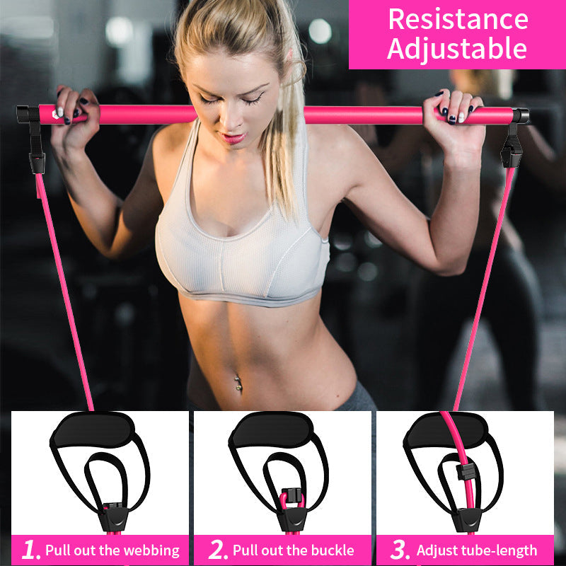 Woman using a pink resistance band with adjustable features, set against a blurred gym background.