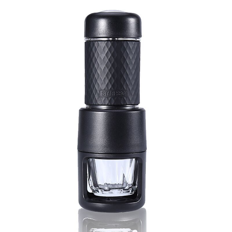 Black portable manual espresso coffee maker with compact travel design, textured grip, pressure brewing system and reusable glass espresso cup for rich coffee at home, office, camping or travel.