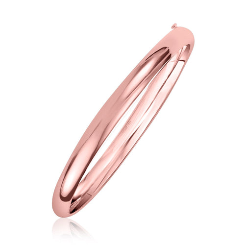 Rose gold bangle on a white background. 14k Rose Gold Fancy Shiny Dome Bangle (5.00 mm)