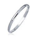 Silver ring on a white background. 14k White Gold Dome Childrens Bangle with a Polished Finish (5.50 mm)