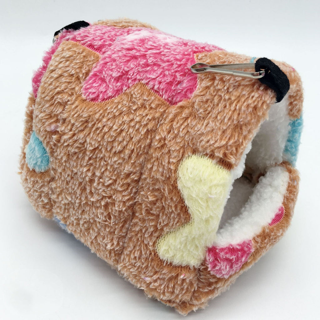 Plush cube-shaped hamster sleeping bag with soft fleece fabric, colorful patchwork accents, and a cozy enclosed hideaway for hamsters, mice, gerbils, and other small pets.