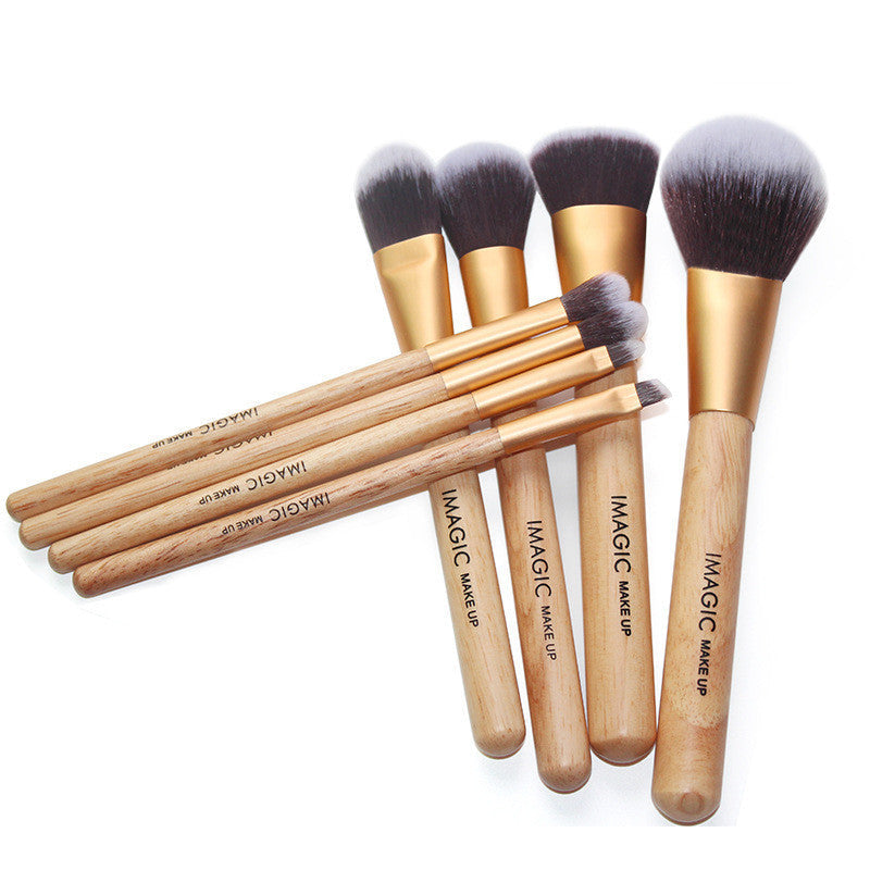 Set of makeup brushes with wooden handles and black bristles on a white background
