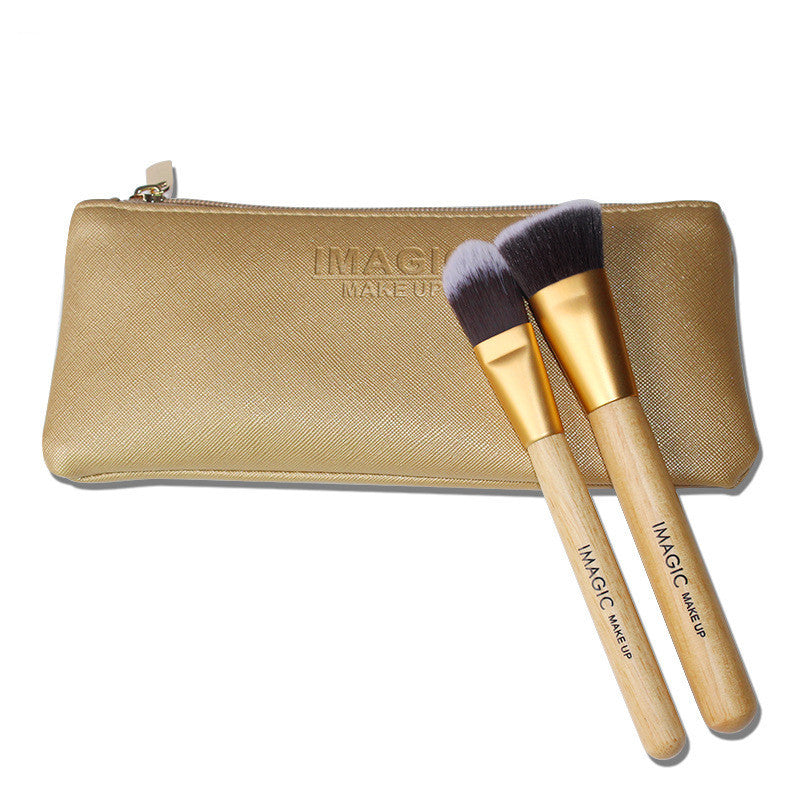 Gold makeup brush set with a pouch on a white background