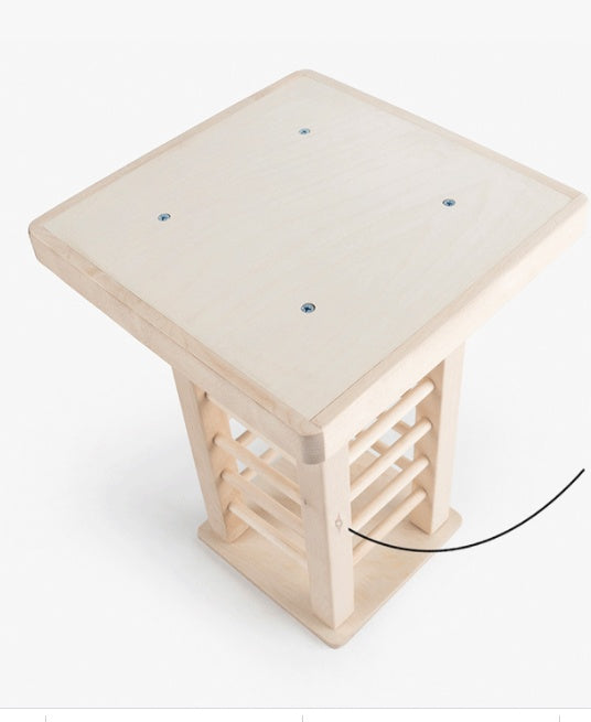 Wooden pet rabbit stool with a white cushion on a white background