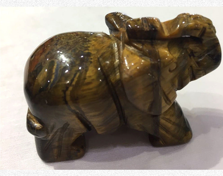 Brown stone elephant figurine on a white background