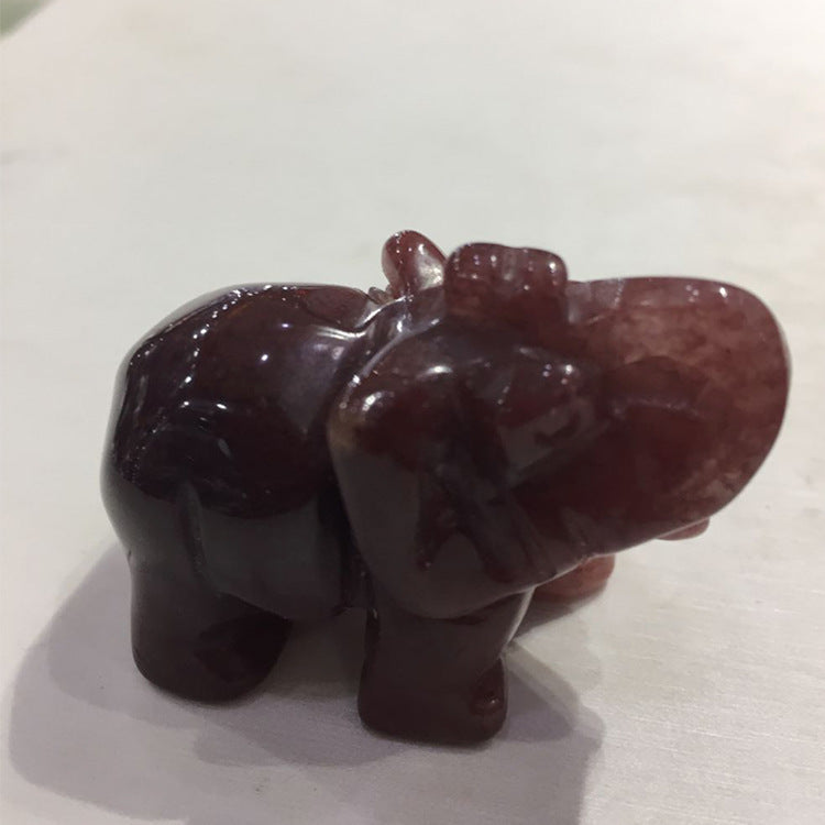 Carved stone elephant on a white background