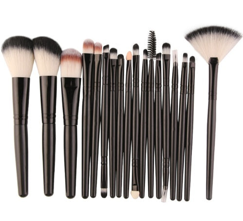 Set of makeup brushes with black handles on a white background
