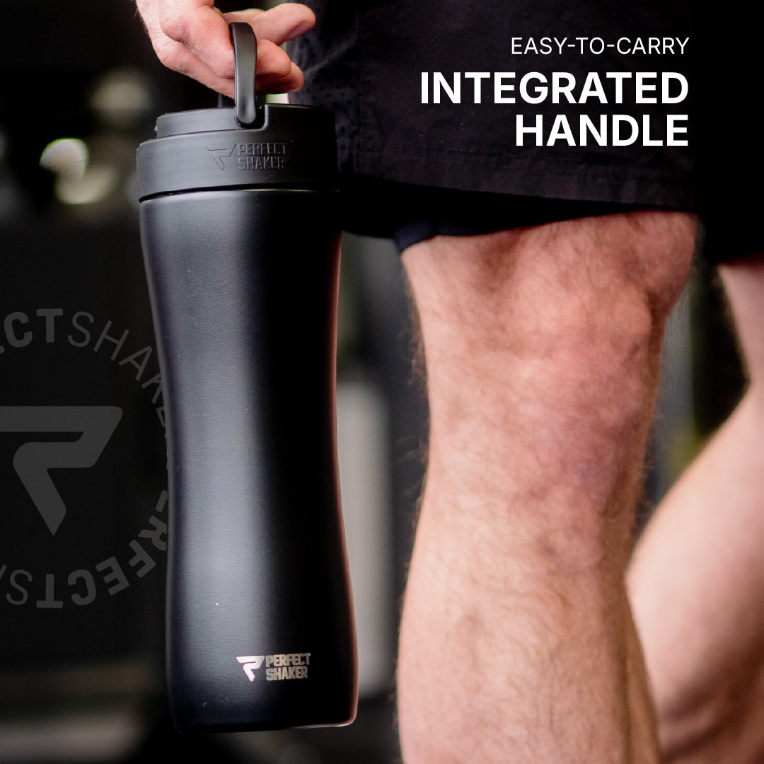 Black shaker bottle with integrated handle held by a person, brand 'Perfect Shaker' visible.