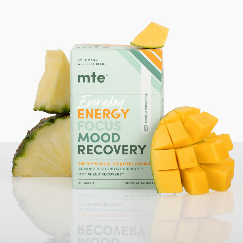 MTE supplement box with pineapple and mango on a white background