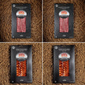 Dehesa Cordobesa Chorizo and Salchichón de Bellota Ibérico 4-pack featuring two packs of sliced Ibérico chorizo and two packs of sliced Ibérico salchichón on a rustic brown textured background.