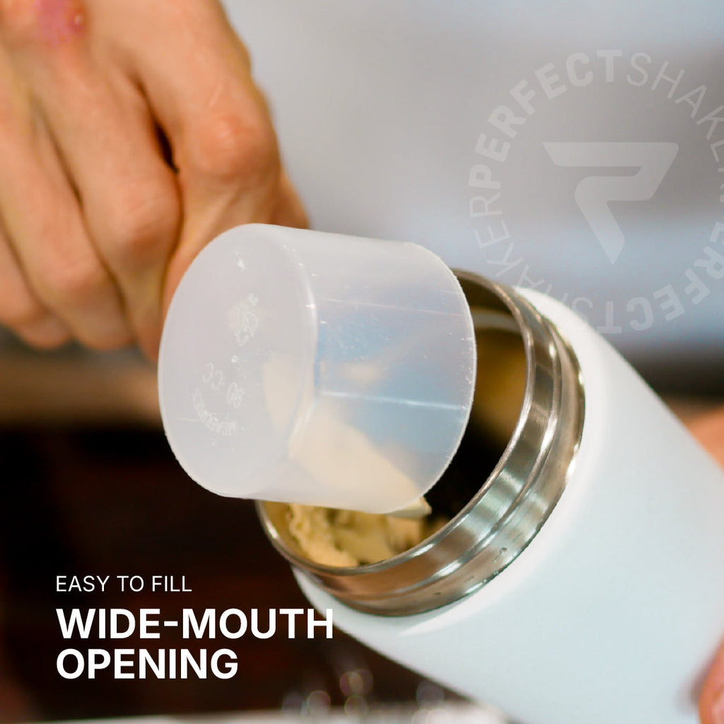 Close-up of a hand filling a white insulated bottle with a translucent wide-mouth measuring cup. Text on the image reads 'EASY TO FILL WIDE-MOUTH OPENING' and a faint 'PERFECTSHAKE' watermark/logo is visible.