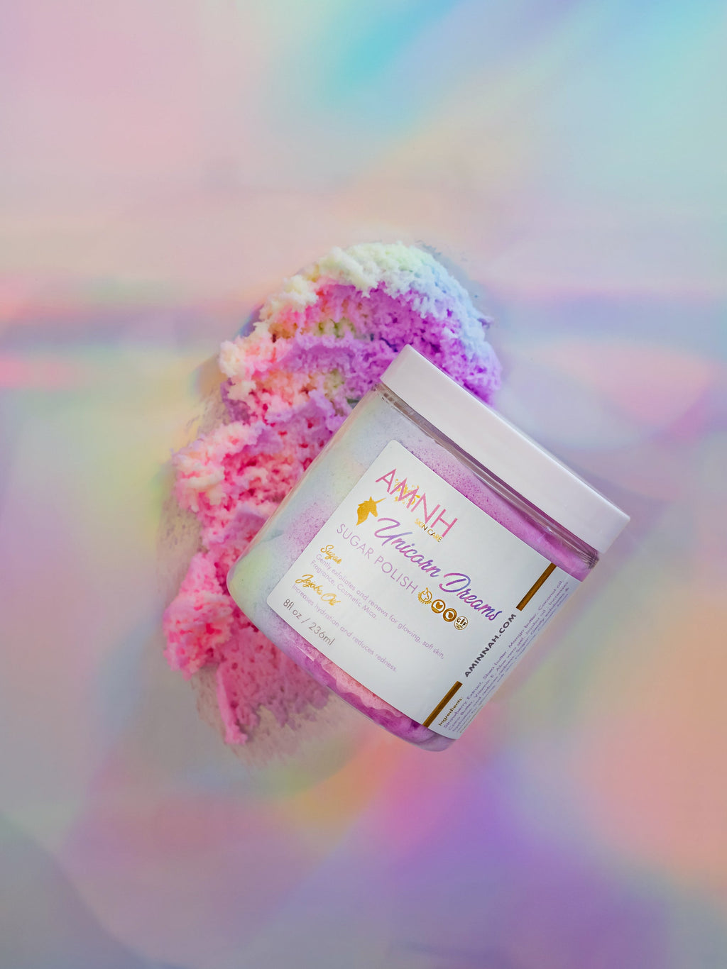 "Unicorn Dreams" Sugar Scrub with natural ingredients for gentle exfoliation and deep hydration, clean beauty, cruelty-free, vegan skincare by a female-owned brand, moisturizing sugar body scrub with shea butter, mango butter, coconut oil, aloe vera, jojoba oil, vitamin E, and shimmering pink finish.