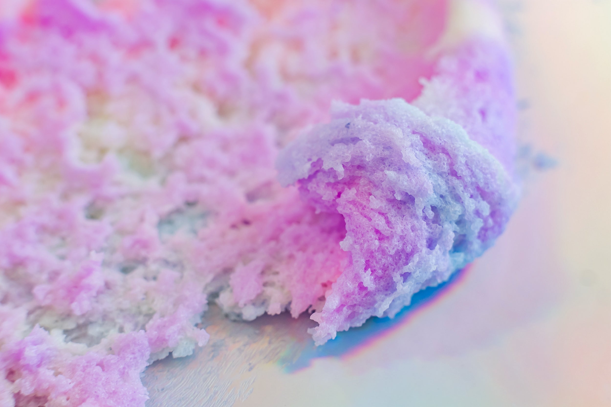 "Unicorn Dreams" Sugar Scrub close-up showcasing fluffy pastel whipped texture made with natural ingredients for gentle exfoliation and deep hydration. Clean beauty, cruelty-free, vegan skincare from a female-owned brand featuring sugar, shea butter, mango butter, cocoa butter, coconut oil, jojoba oil, aloe vera, vitamin E, and shimmering cosmetic mica for soft, radiant skin.