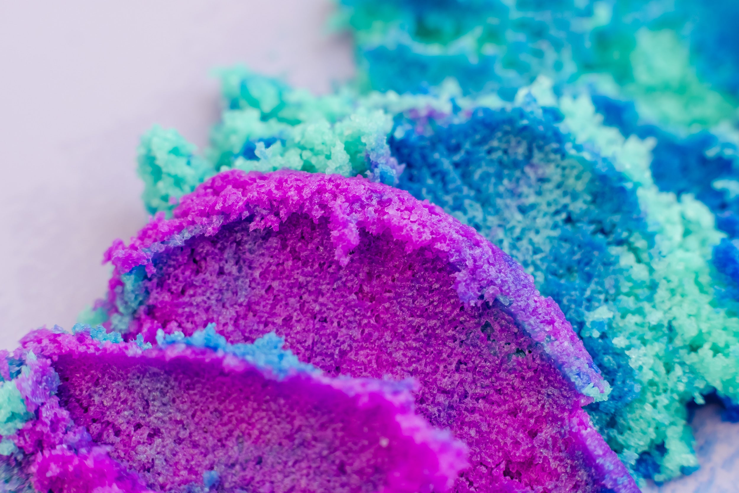 AMINNAH Galaxy Sugar Scrub close-up showcasing vibrant purple and blue exfoliating sugar crystals. Clean beauty, cruelty-free, vegan body scrub made with natural ingredients to gently exfoliate, hydrate, reduce redness, and reveal soft, glowing skin. Female-owned brand available at Tree of Life Grocers.