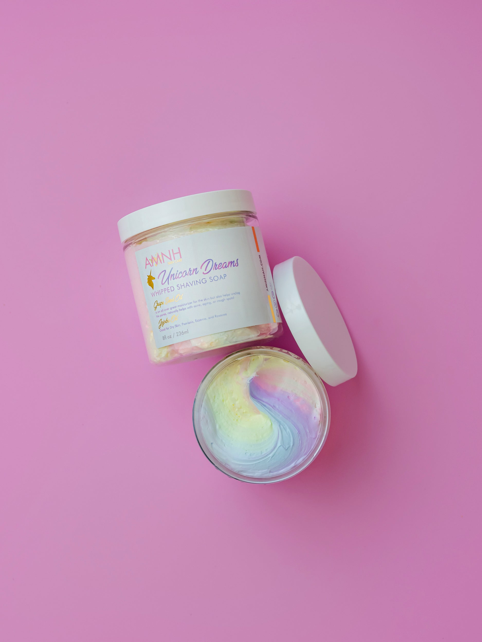 AMINNAH Unicorn Dreams Bundle featuring whipped body butter, sugar scrub and nourishing body oil on a pink background. Clean beauty skincare gift set made with natural ingredients, vegan, cruelty-free, paraben-free, gluten-free and packaged in recyclable packaging. Female-owned brand luxury self-care collection for soft, radiant skin.