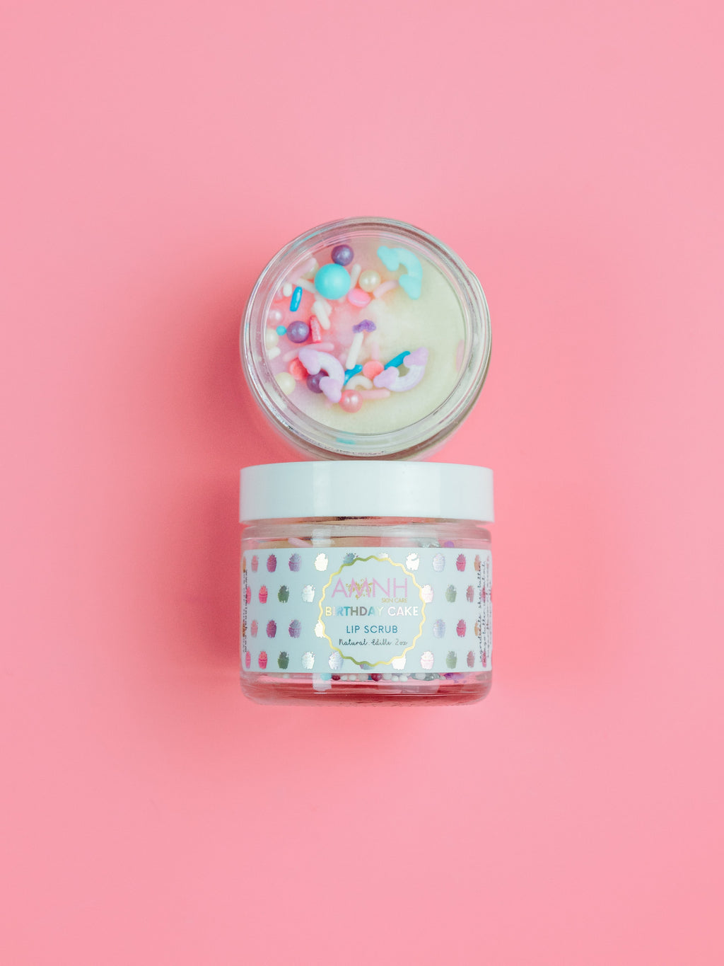 AMINNAH Birthday Cake Lip Scrub in a glass jar with colorful sprinkles, made with natural ingredients for gentle exfoliation and soft, smooth lips. Clean beauty, cruelty-free, vegan lip care from a female-owned brand, perfect for nourishing and hydrating dry lips.