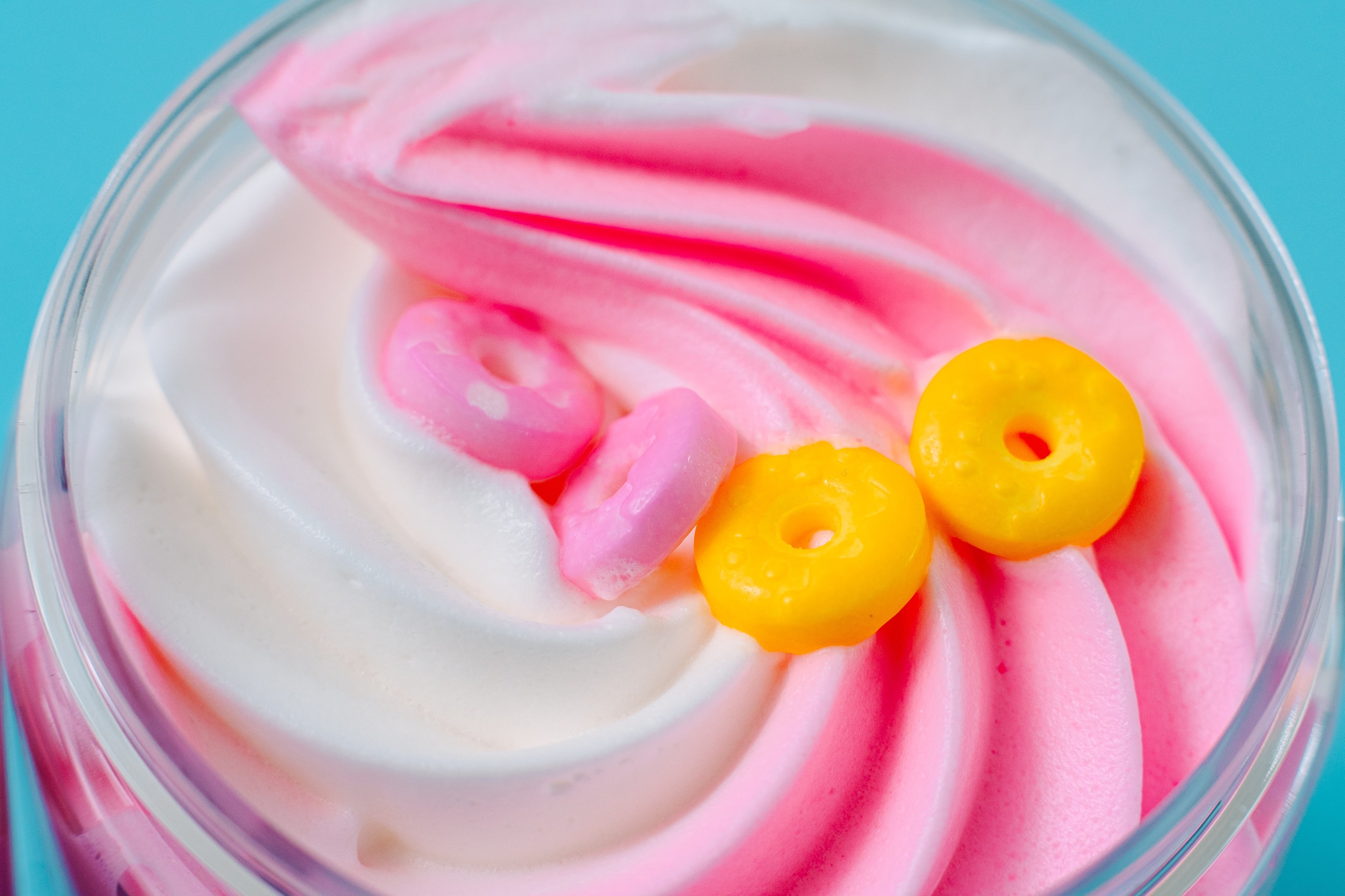 Close-up of **"I Donut Know What I'll Do Without You!" Whipped Body Butter** with fluffy pink and white swirls topped with colorful donut-shaped sprinkles, showcasing a rich, creamy texture for deep hydration and a playful dessert-inspired skincare experience.