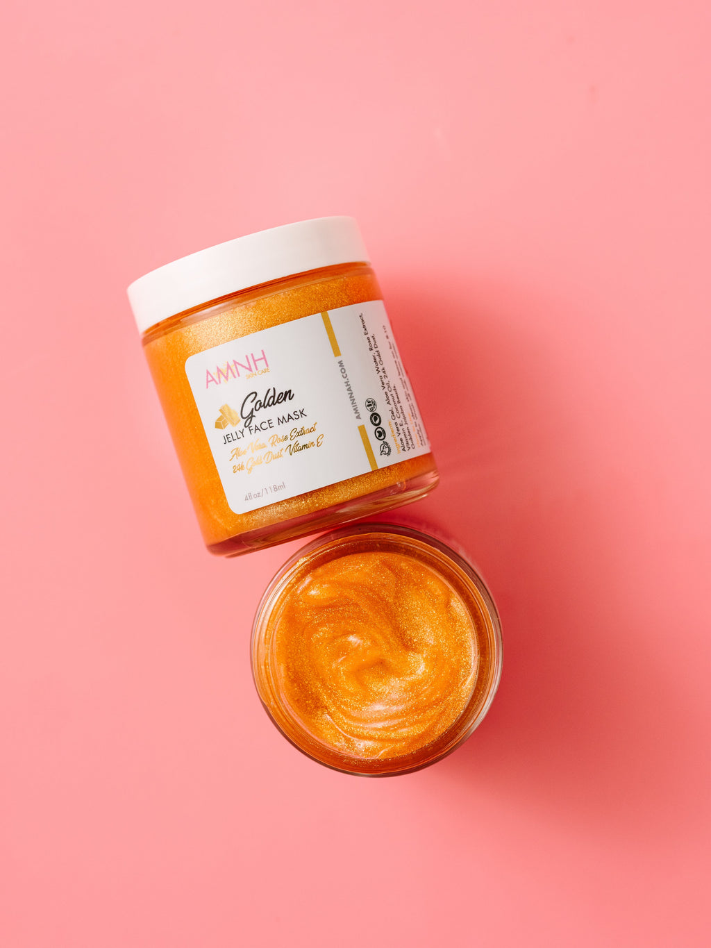 24K Golden Jelly Face Mask with 24K gold flakes, aloe vera, rose extract, vitamin E, coconut oil and jojoba beads in a glass jar. Clean beauty, cruelty-free, vegan skincare made with natural ingredients by a female-owned brand to hydrate, soothe, firm, brighten and support anti-aging for radiant, glowing skin.