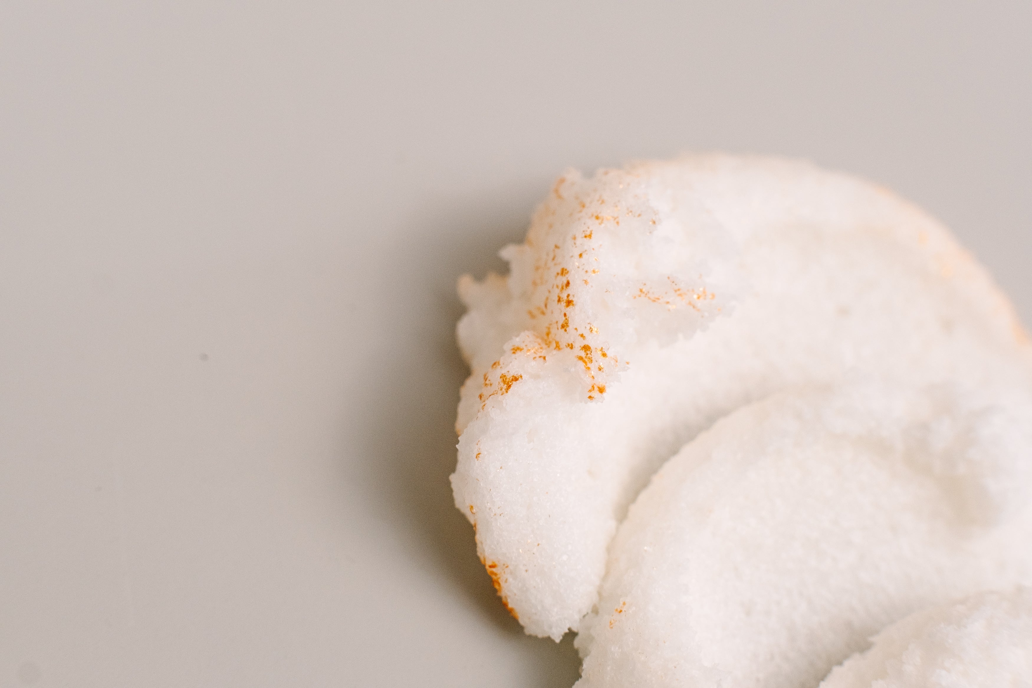 Close-up of AMINNAH® "Life is S’more Fun With You" Sugar Scrub featuring fluffy whipped sugar scrub with shimmering 24K gold dust. Clean beauty, cruelty-free, vegan body exfoliant made with shea butter, mango butter, cocoa butter, coconut oil, jojoba oil, aloe vera, and vitamin E for soft, smooth, hydrated skin. Luxury skincare by a women-owned brand.