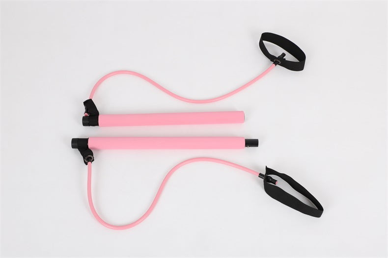 Pink resistance band with black handles on a light gray background