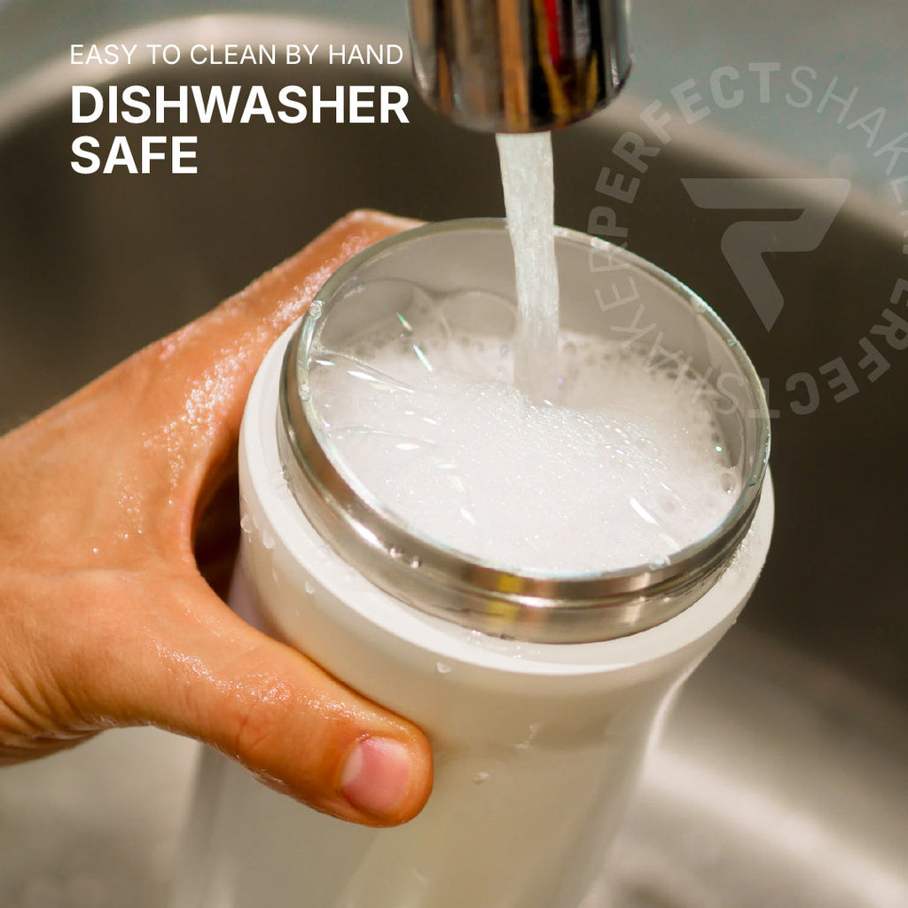 A hand holds a white insulated tumbler under running water in a sink, with text reading 'EASY TO CLEAN BY HAND DISHWASHER SAFE' and a faint 'PERFECTSHA.