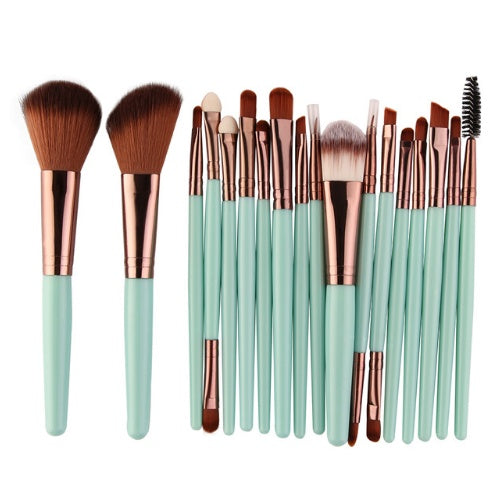 Set of makeup brushes with light green turquoise handles and rose gold ferrules on a white background