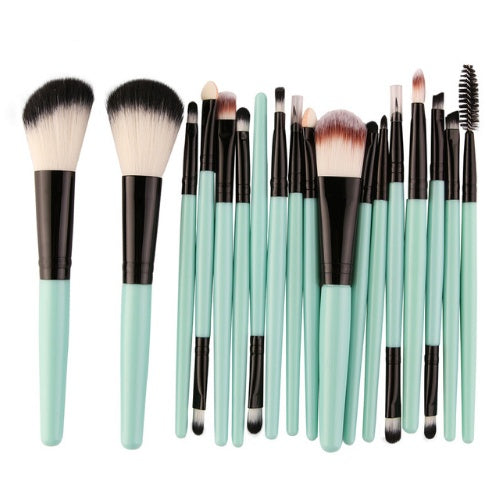 Set of light green turquoise makeup brushes with green handles on a white background