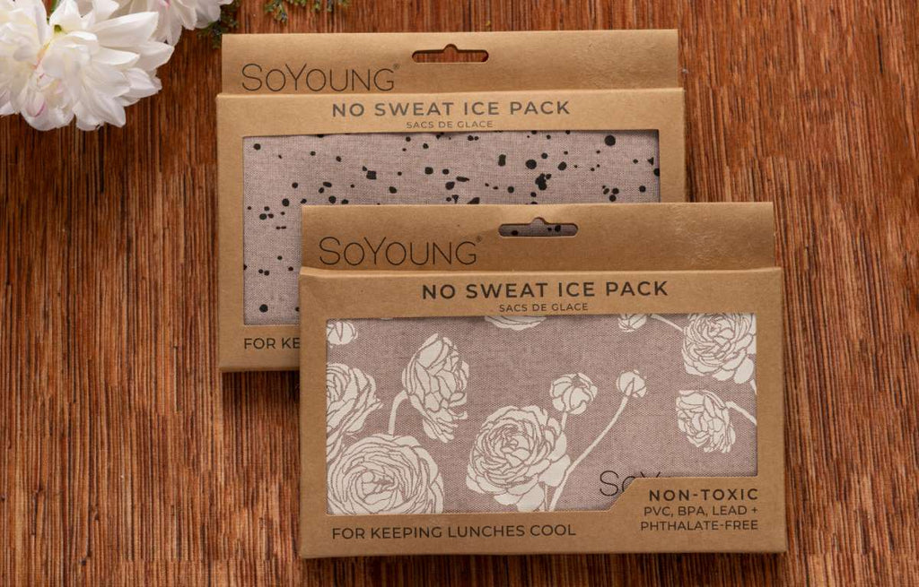 Two SOYOUNG No Sweat Ice Packs, reusable cold packs for keeping lunches and food cool, non-toxic PVC BPA LEAD and phthalate-free, floral and neutral fabric designs on wooden surface with white flowers, reusable lunchbox ice packs for work school travel picnics and everyday meal storage
