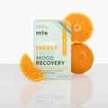 Box labeled 'mte' with text 'Energy Focus Mood Recovery' surrounded by oranges on a reflective surface.