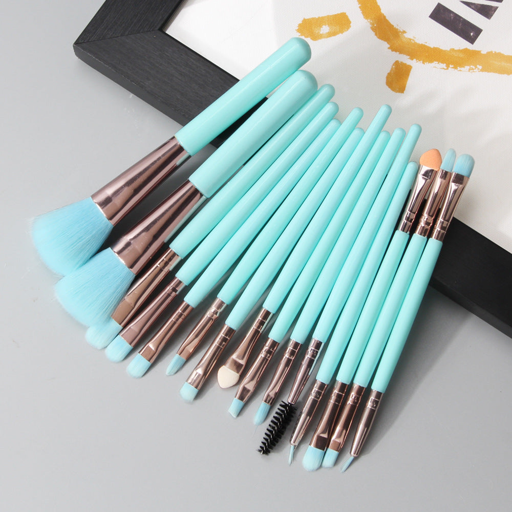 Set of turquoise light blue makeup brushes with turquoise handles on a light gray surface