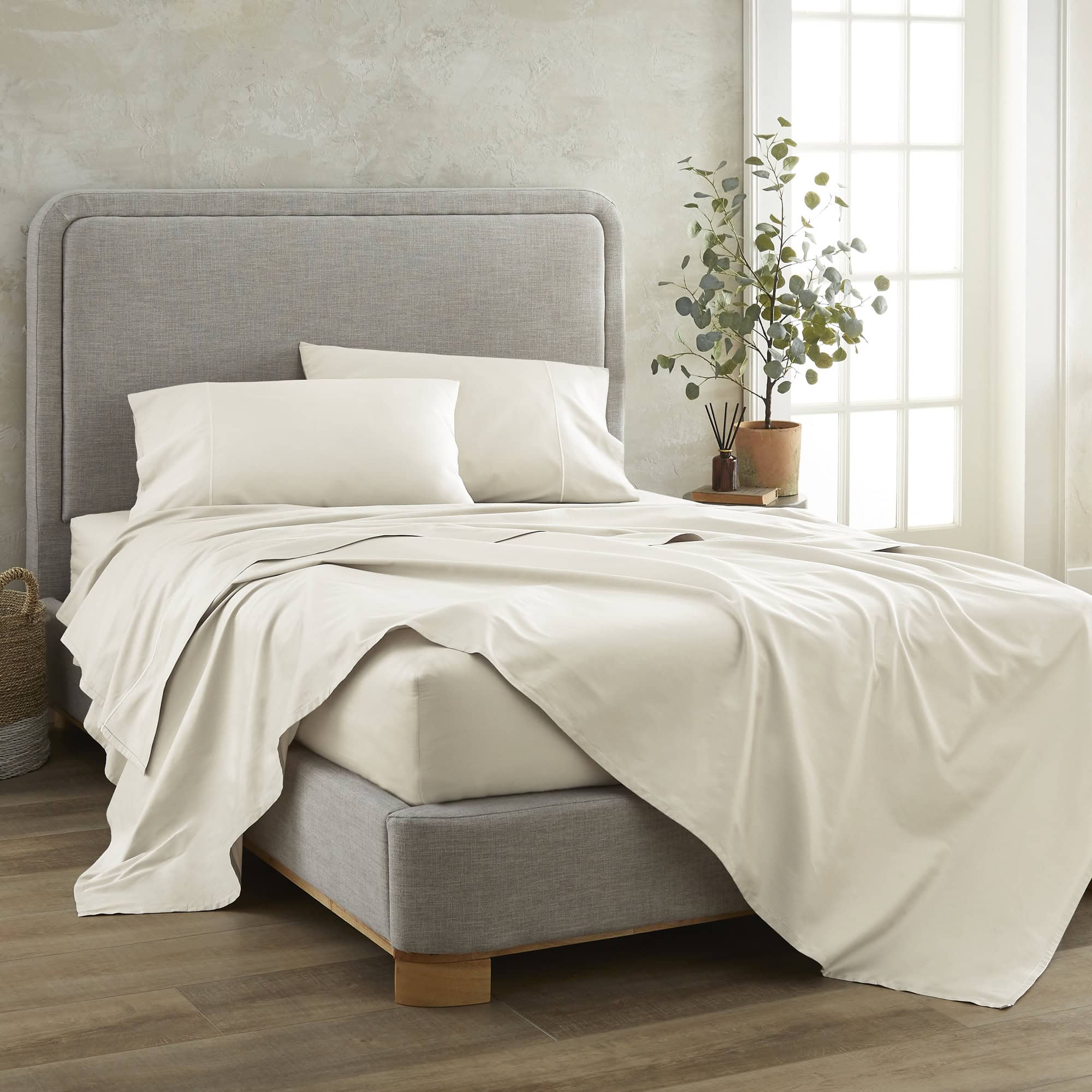 Gray upholstered bed with white bedding in a bright bedroom, 100% GOTS-Certified &amp; Fairtrade-Certified Organic Cotton
Made in India
High quality, dense 500-thread-count sateen weave becomes luxuriously soft with washing
Durable elastic band
Non-toxic, hypoallergenic, naturally breathable, and cooling
16" deep pocket, ideal for plush mattresses
Easy Care, Machine Wash and Tumble Dry