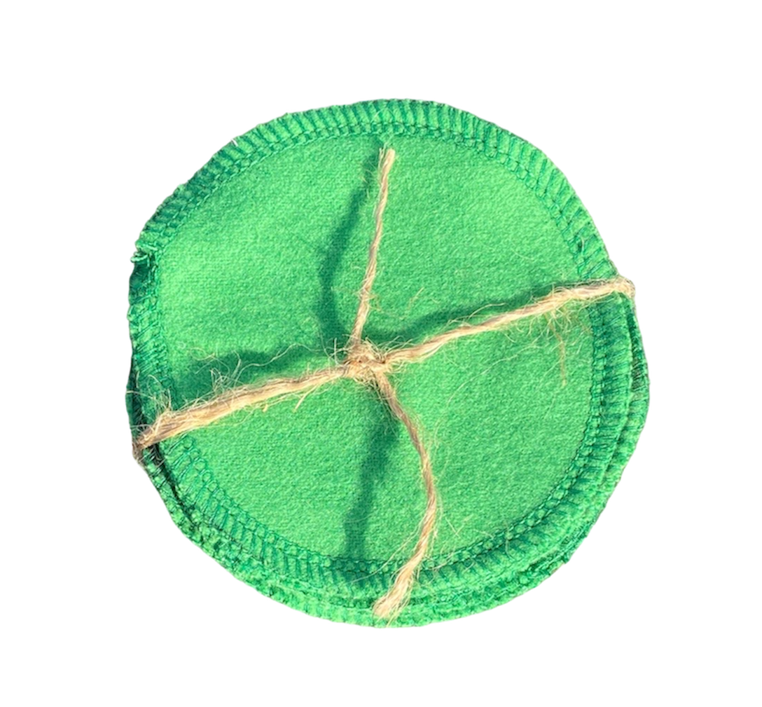 Circular, reusable cotton grooming pad with decorative brown stitching, shown isolated on a clean white background.
