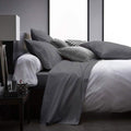 Gray bedding set on a bed in a modern bedroom with a nightstand. 4-Piece Set: Ultra Soft 1800 Series Bamboo Blend Sheets
