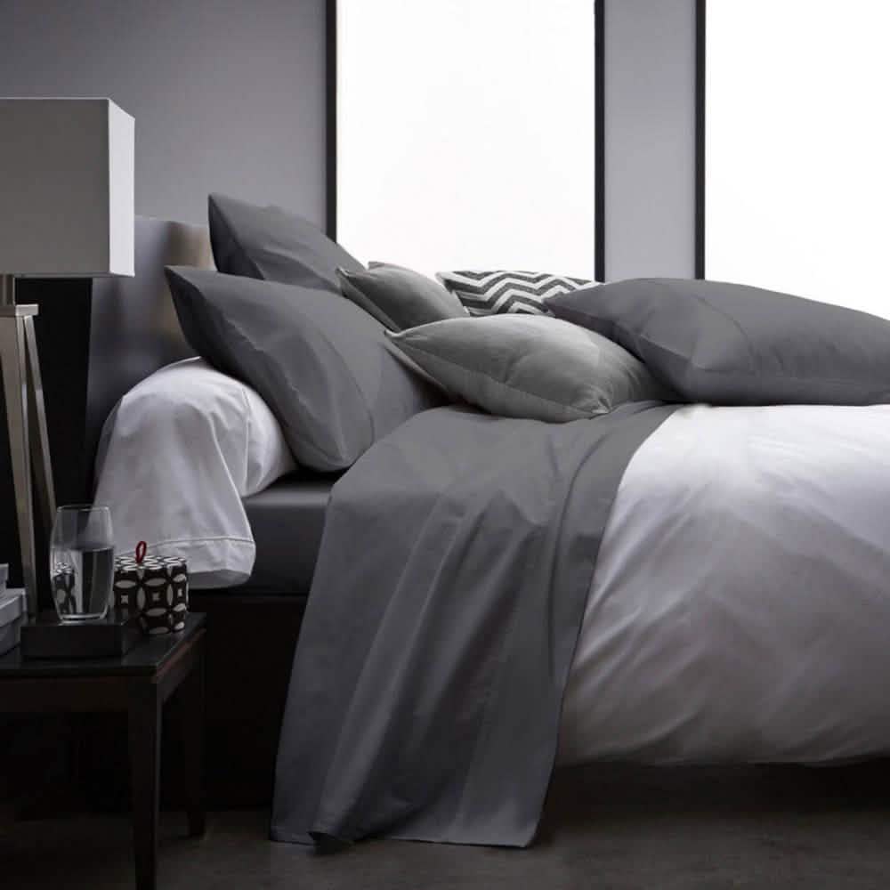 Gray bedding set on a bed in a modern bedroom with a nightstand. 4-Piece Set: Ultra Soft 1800 Series Bamboo Blend Sheets