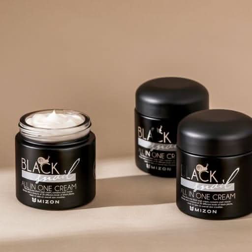 Three jars of MIZON Black Snail All In One Cream on a beige background, with one open jar revealing rich white moisturizing cream. Korean snail mucin face moisturizer for hydration, skin repair, wrinkle care, and improved skin elasticity.