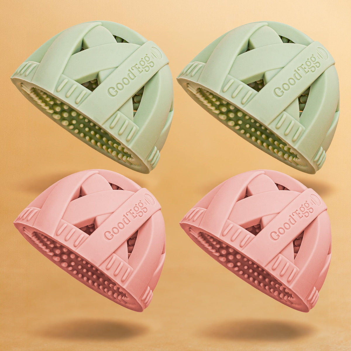 Four pastel silicone GoodEgg egg cleaning brushes in mint green and blush pink, designed with flexible scrubbing nubs and nesting drain design, displayed on a beige background.