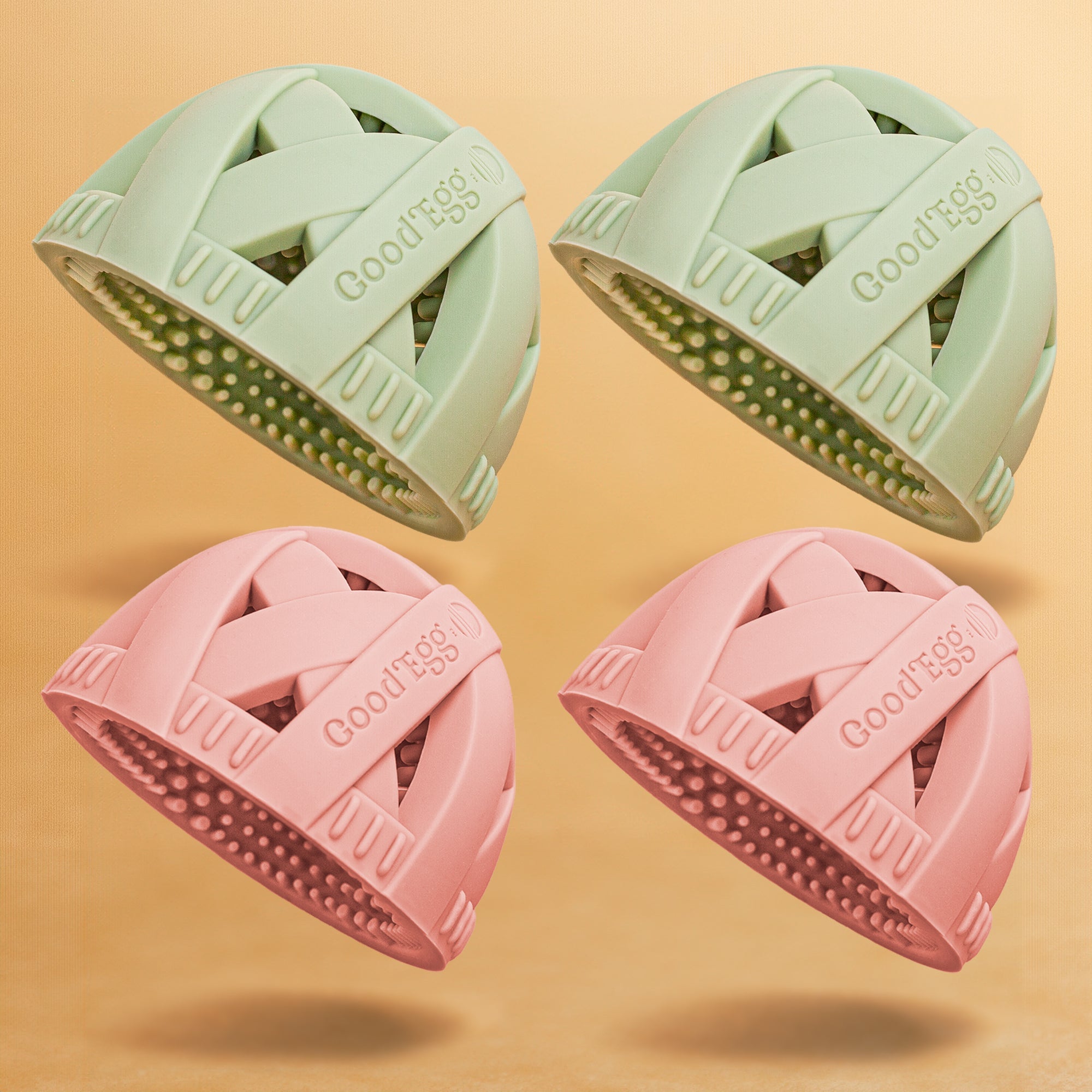 Four pastel silicone GoodEgg egg cleaning brushes in mint green and blush pink, designed with flexible scrubbing nubs and nesting drain design, displayed on a beige background.