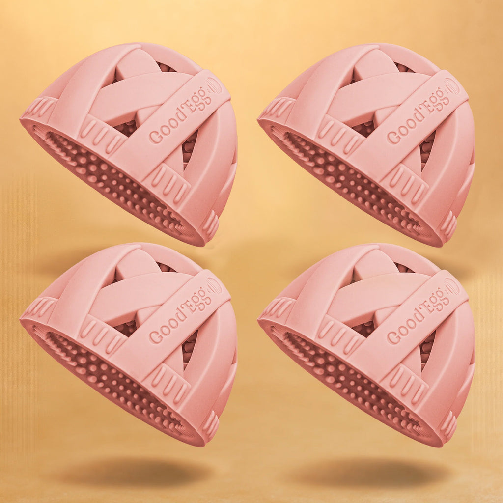 4-pack of pink GoodEgg silicone egg cleaning brushes with flexible scrubbing nubs, designed for washing fresh chicken eggs, displayed on a soft yellow background.