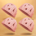 4-pack of pink GoodEgg silicone egg cleaning brushes with flexible scrubbing nubs, designed for washing fresh chicken eggs, displayed on a soft yellow background.