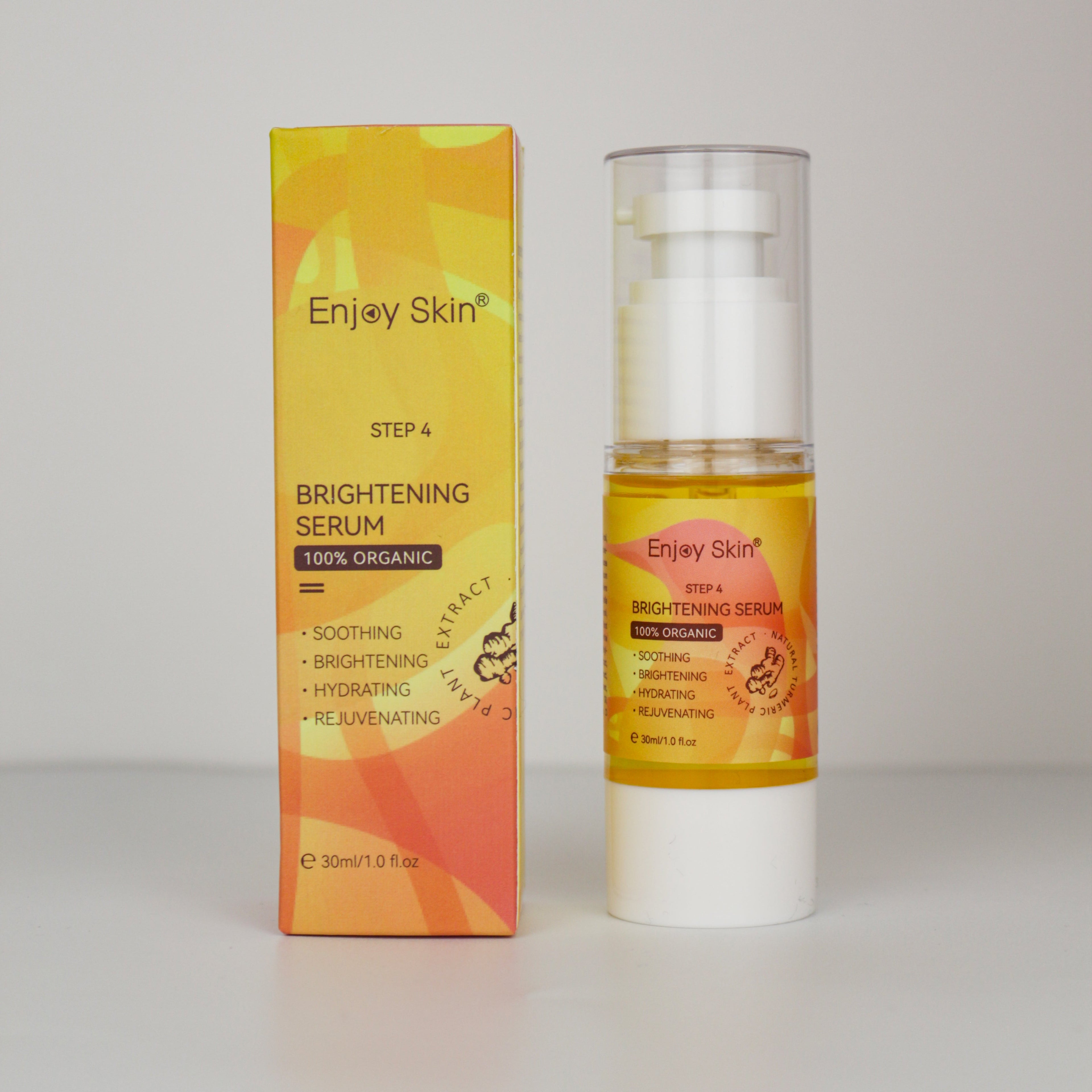 Enjoy Skin Brightening Serum bottle with matching product packaging displayed on a light gray background. Part of the 5-Piece Organic Vegan Turmeric Skincare Set, this brightening facial serum helps improve the appearance of uneven skin tone, hydrate the skin, and promote a smoother, more radiant-looking complexion. 100% Organic