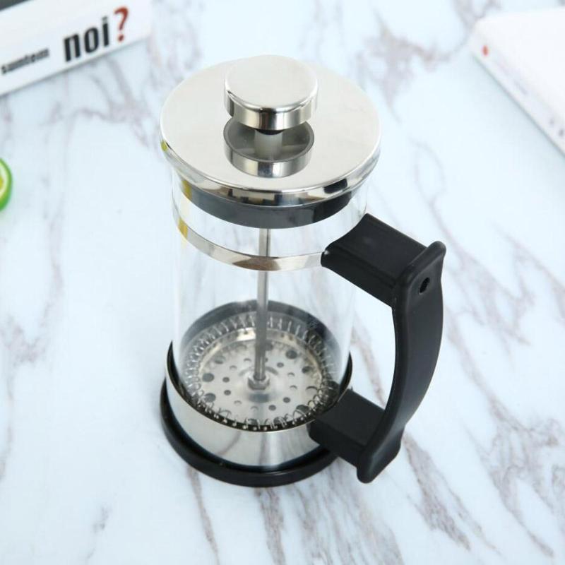 French press coffee maker on a marble surface