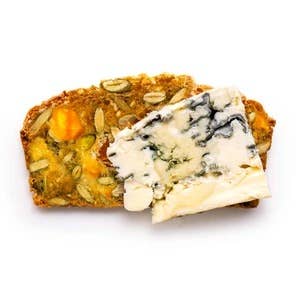 Bread slice with blue cheese and vegetables on a white background