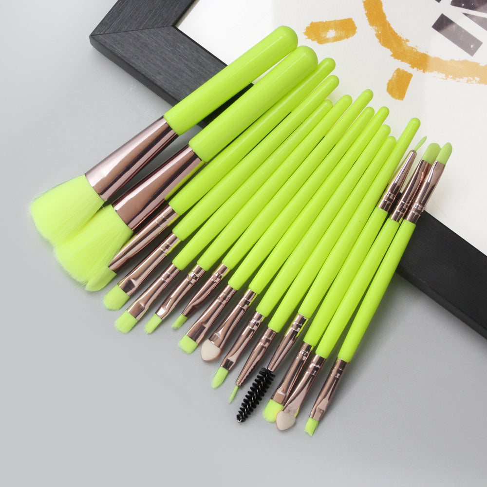 Set of 15 makeup brushes with lime green handles on a light gray background