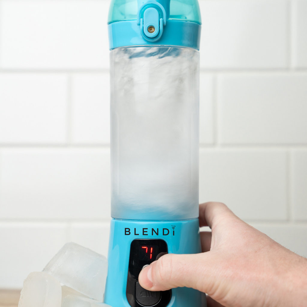 Blue Pro+ 17oz portable ice-crushing blender blending ice, featuring a travel cup and compact design for smoothies, shakes and frozen drinks.