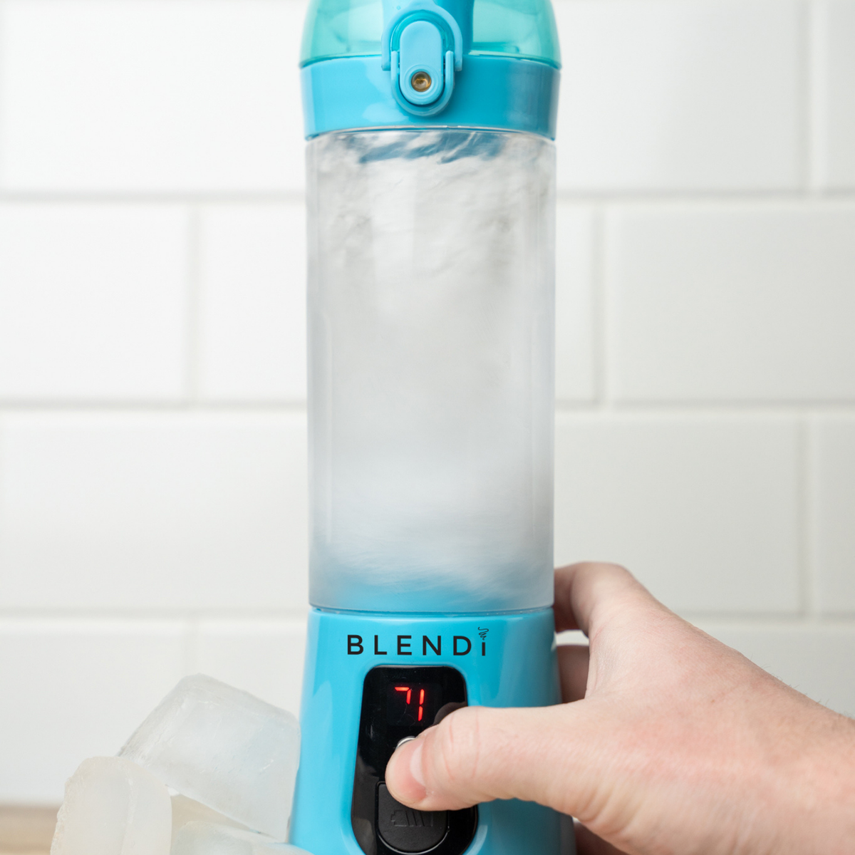 Blue Pro+ 17oz portable ice-crushing blender blending ice, featuring a travel cup and compact design for smoothies, shakes and frozen drinks.