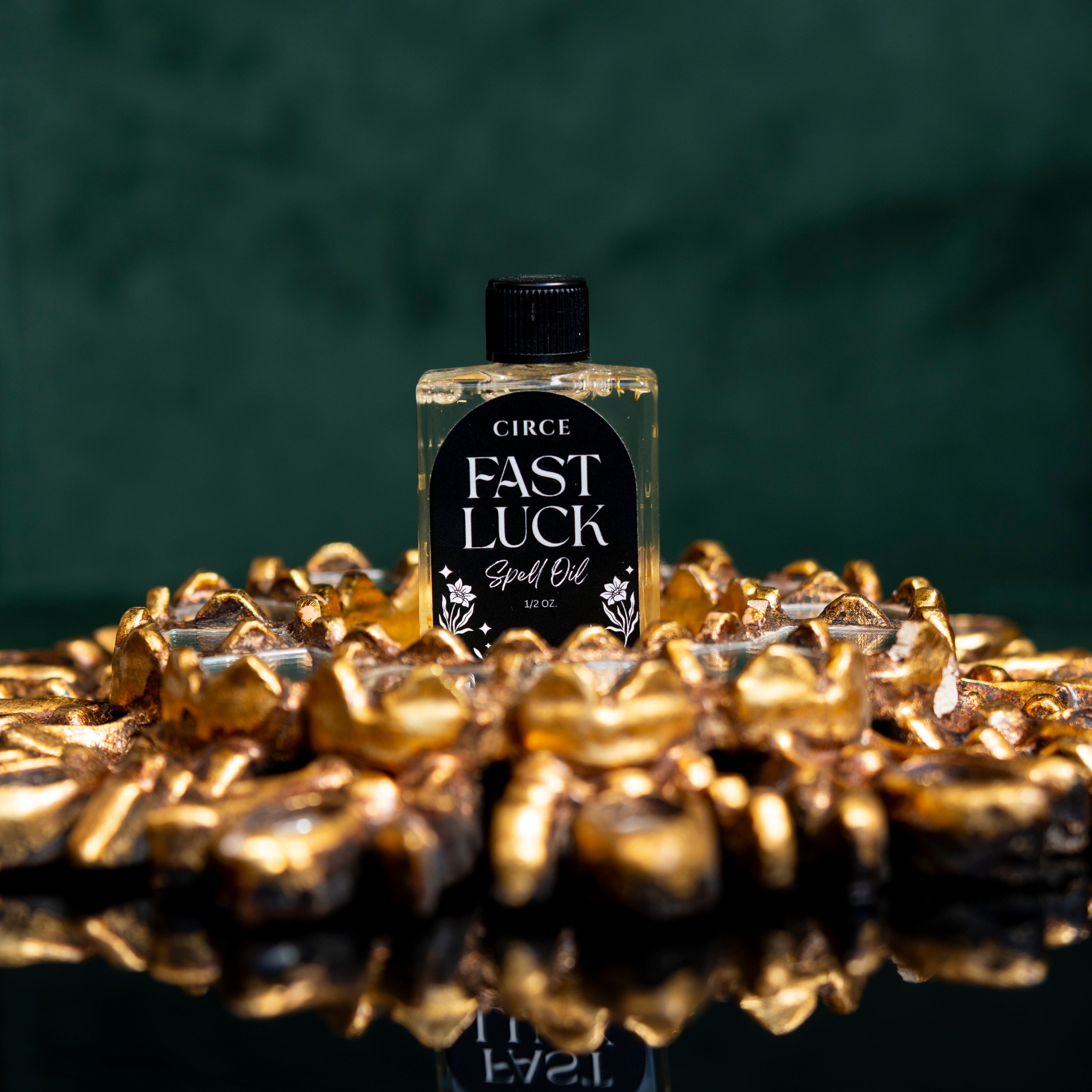 Circe Fast Luck Ritual Spell Oil for good fortune, prosperity, success, opportunity, abundance and manifestation, 1/2 oz bottle surrounded by gold stones